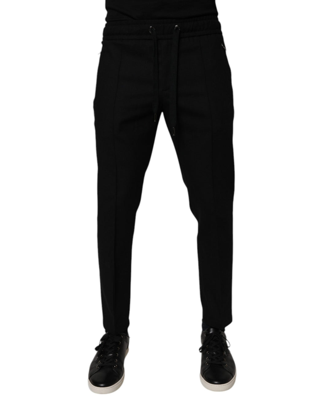 Pantalon homme Dolce & Gabbana en laine noire, coupe skinny jogger, avec ceinture à cordon et poches latérales.