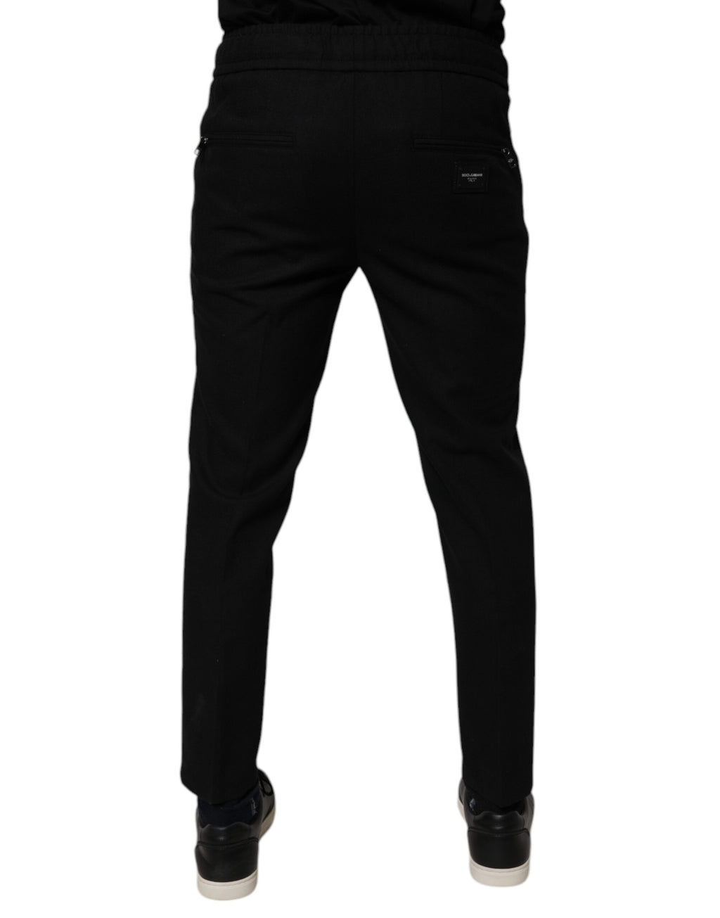 Pantalon slim en laine noire Dolce & Gabbana pour homme, jogger ajusté avec taille élastique et détails modernes.