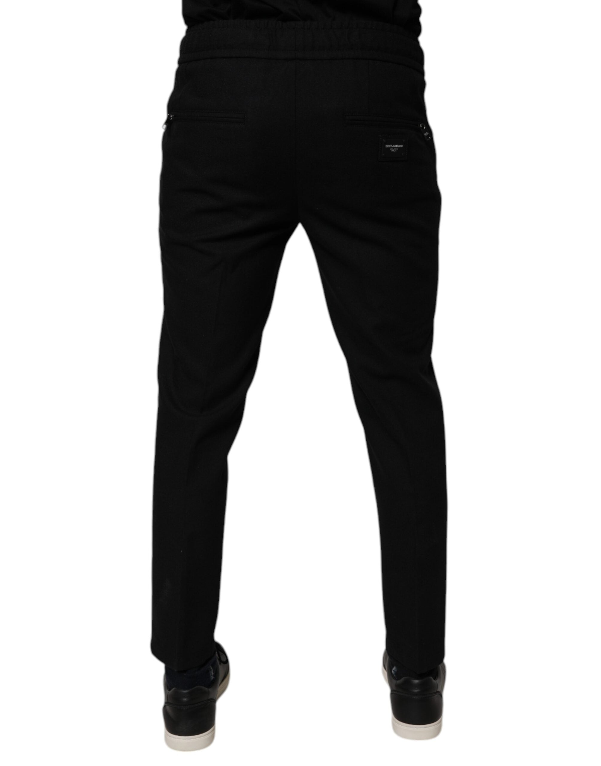 Pantalon slim en laine noire Dolce & Gabbana pour homme, jogger ajusté avec taille élastique et détails modernes.