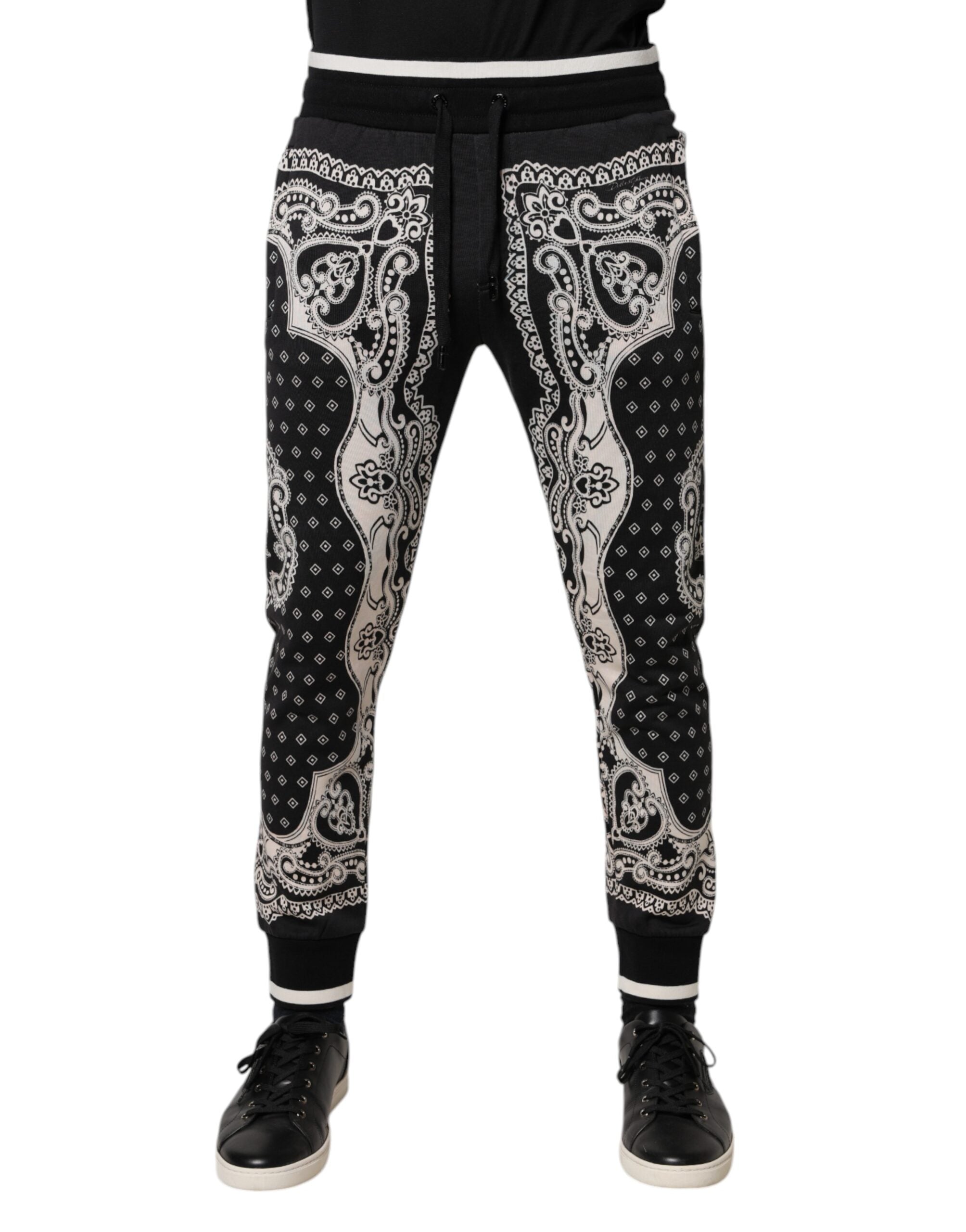 Pantalons joggers Dolce & Gabbana en coton noir avec bande de style bandana, ajustés et confortables, visibles en détail.