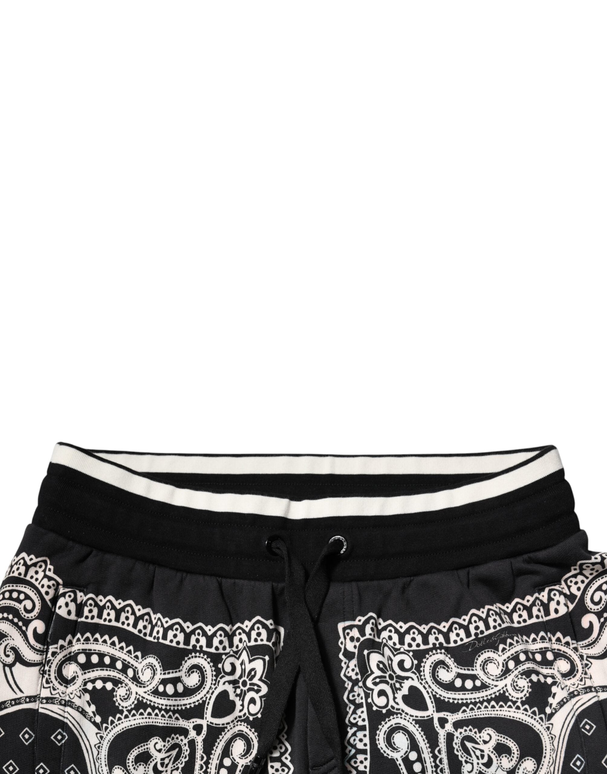 Pantalon de survêtement noir Dolce & Gabbana en coton avec bandeau, jogger, design moderne, visible détails du tissu et de la coupe.