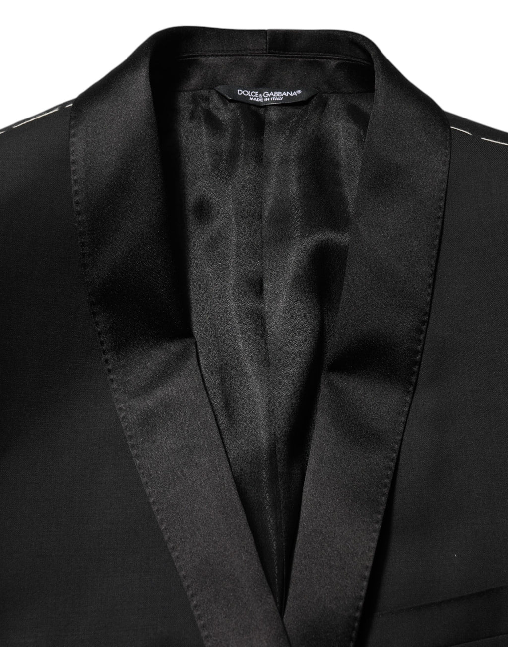 Blazer homme Dolce & Gabbana en laine noire avec un bouton doré, costume élégant et moderne.