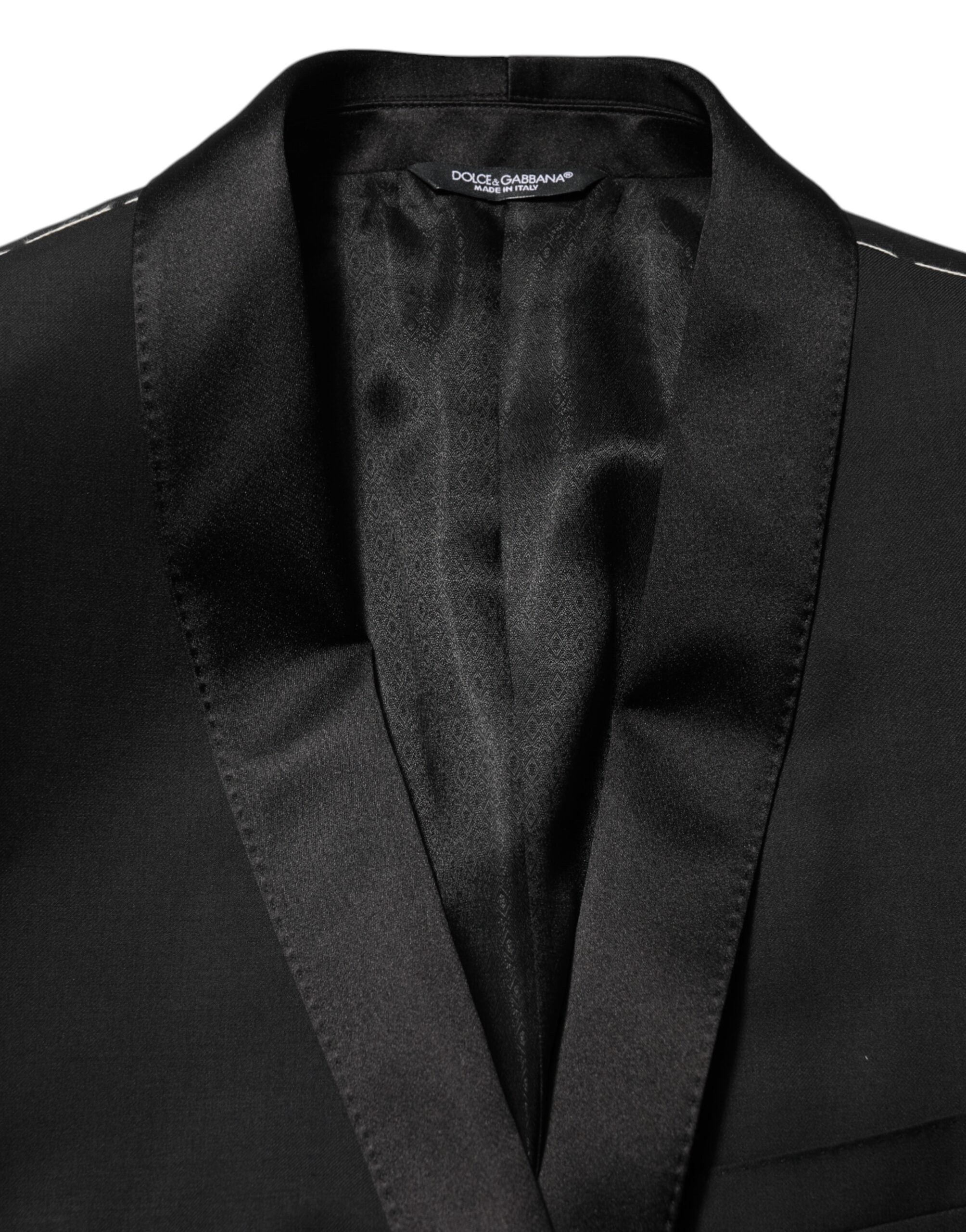 Blazer homme Dolce & Gabbana en laine noire avec un bouton doré, costume élégant et moderne.
