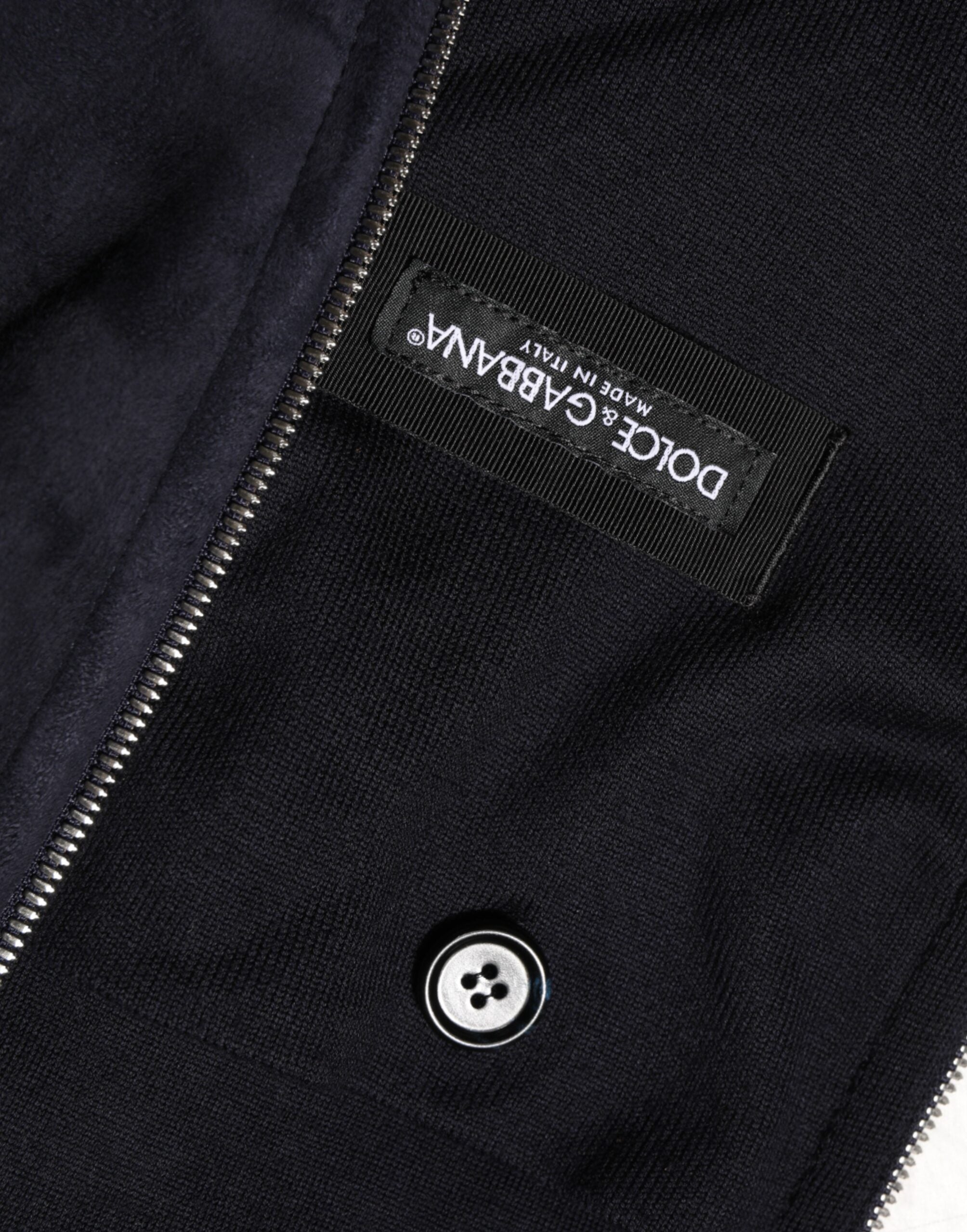 Veste blouson Dolce & Gabbana en cuir noir avec capuche et fermeture éclair complète, décontractée et élégante.