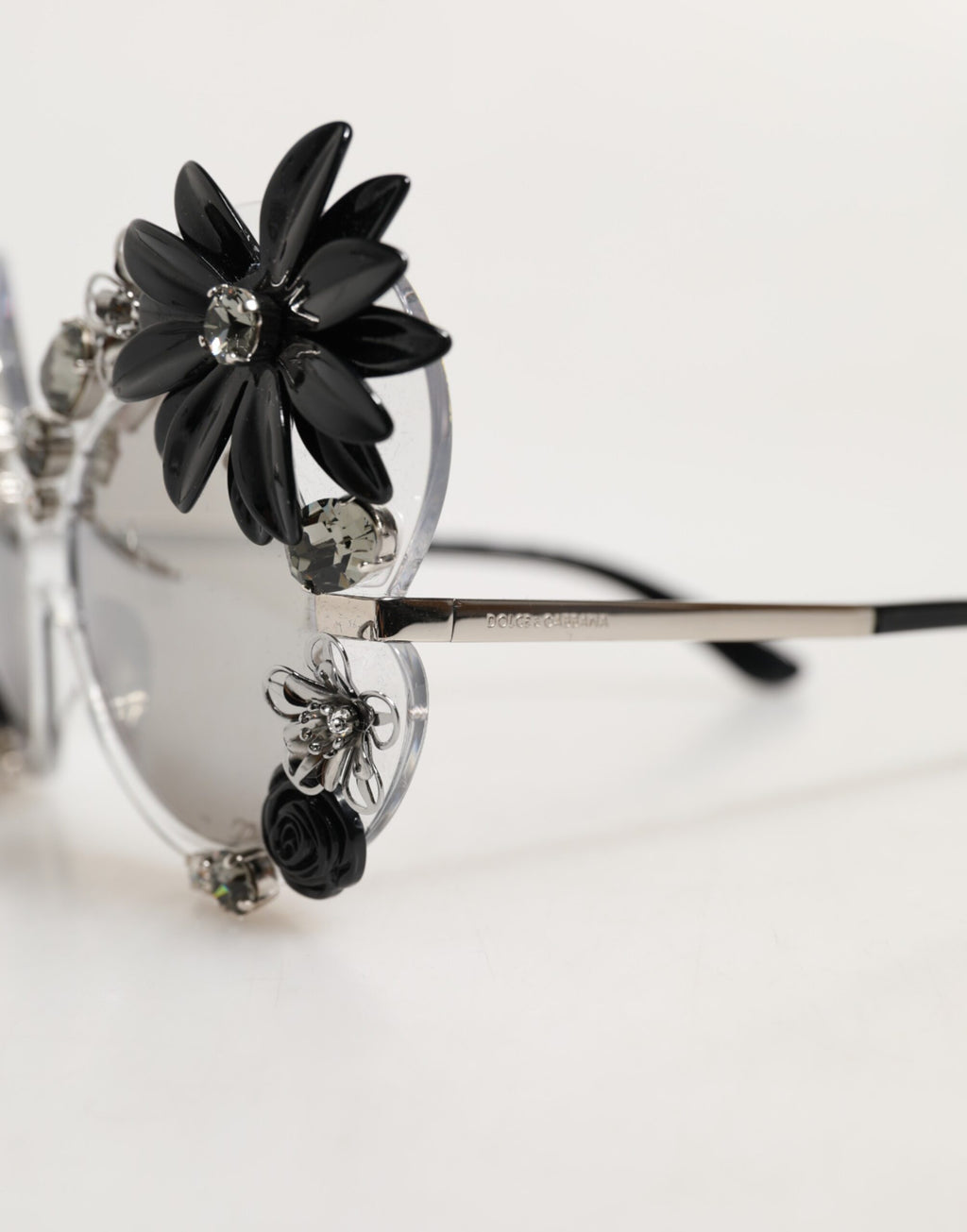 Lunettes de soleil rondes transparentes Dolce & Gabbana DG4292 avec détails en cristaux et motifs floraux élégants.