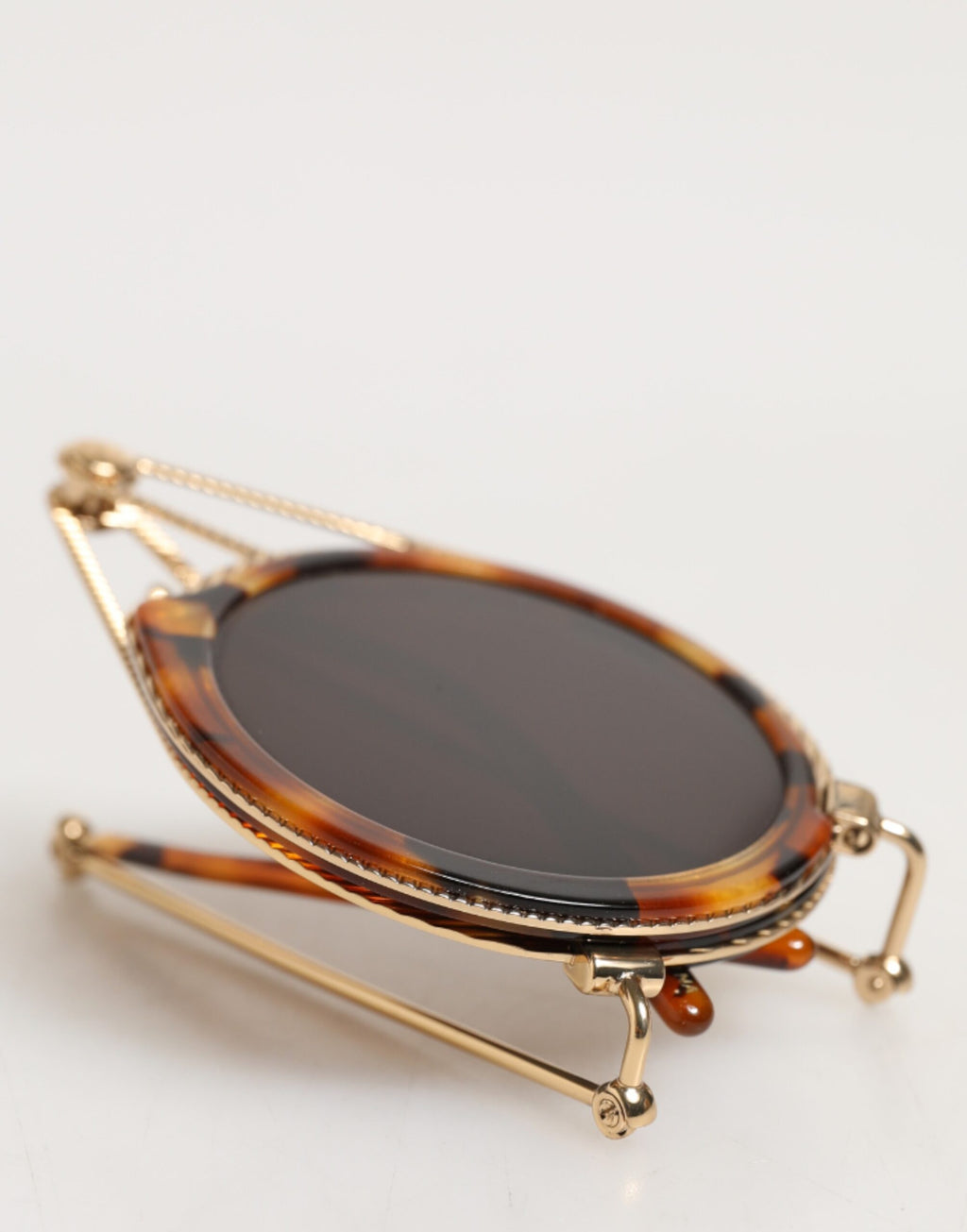Lunettes de soleil Dolce & Gabbana Havana dorées avec monture en métal et design fait main, style élégant et sophistiqué.