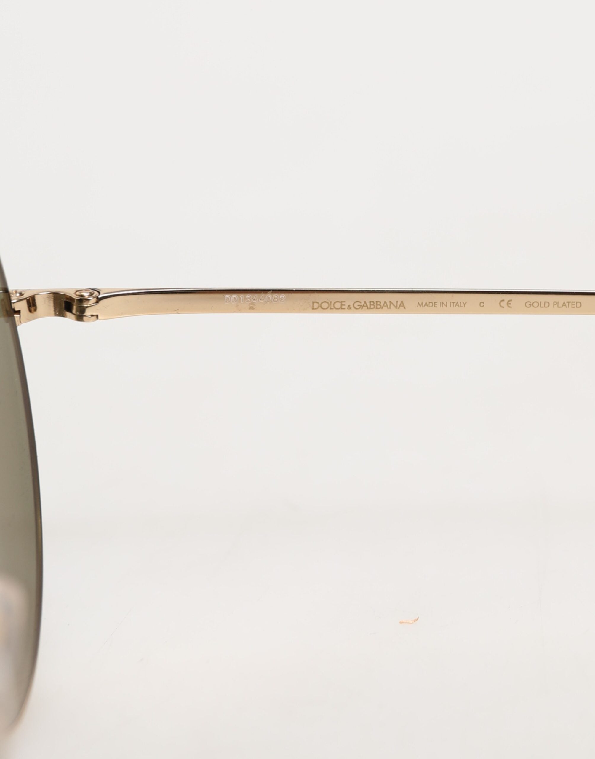Lunettes de soleil rondes en métal doré de Dolce & Gabbana, style élégant et sophistiqué, vue de face avec monture brillante.