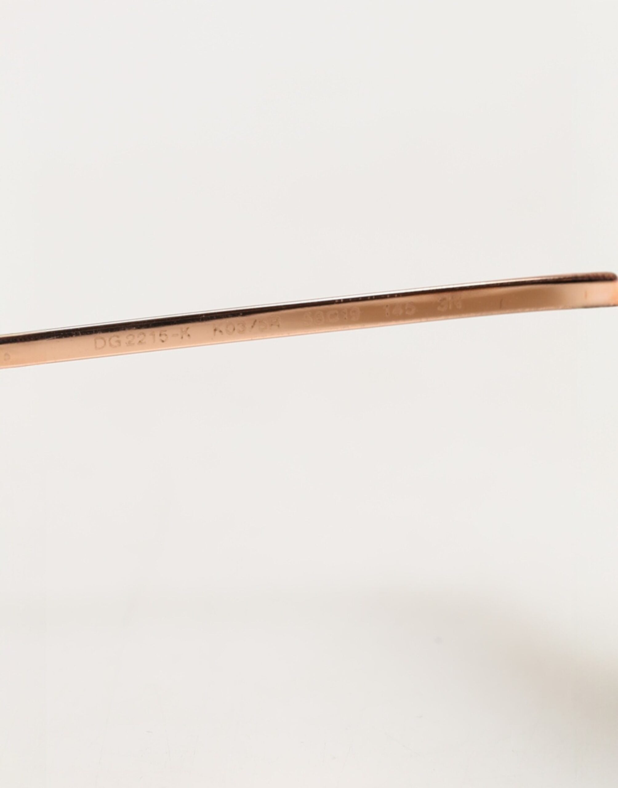 Lunettes de soleil rondes en métal doré Dolce & Gabbana DG2215K, style élégant et moderne, avec monture dorée brillante.