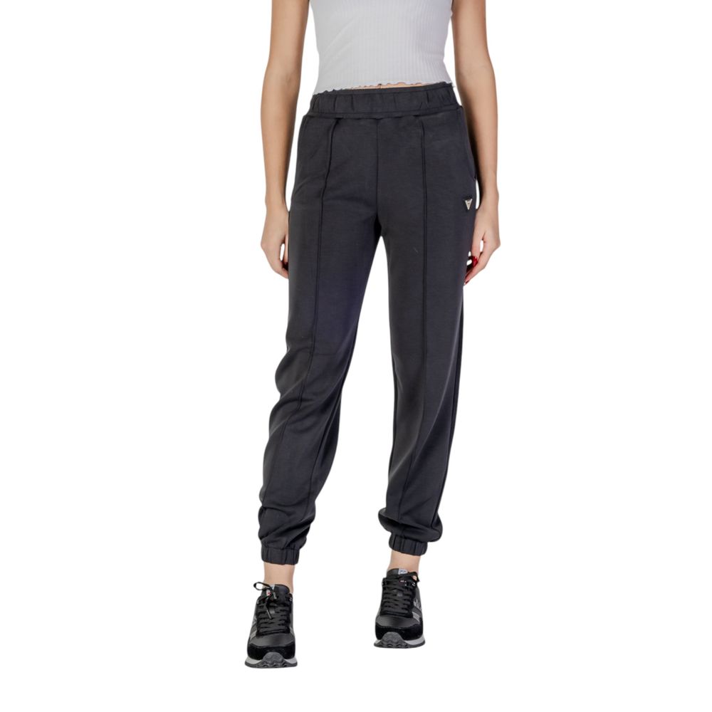 Pantalons de jogging Guess Active en polyester noir, vêtements de sport pour hommes, visibles en détail dans l'image.