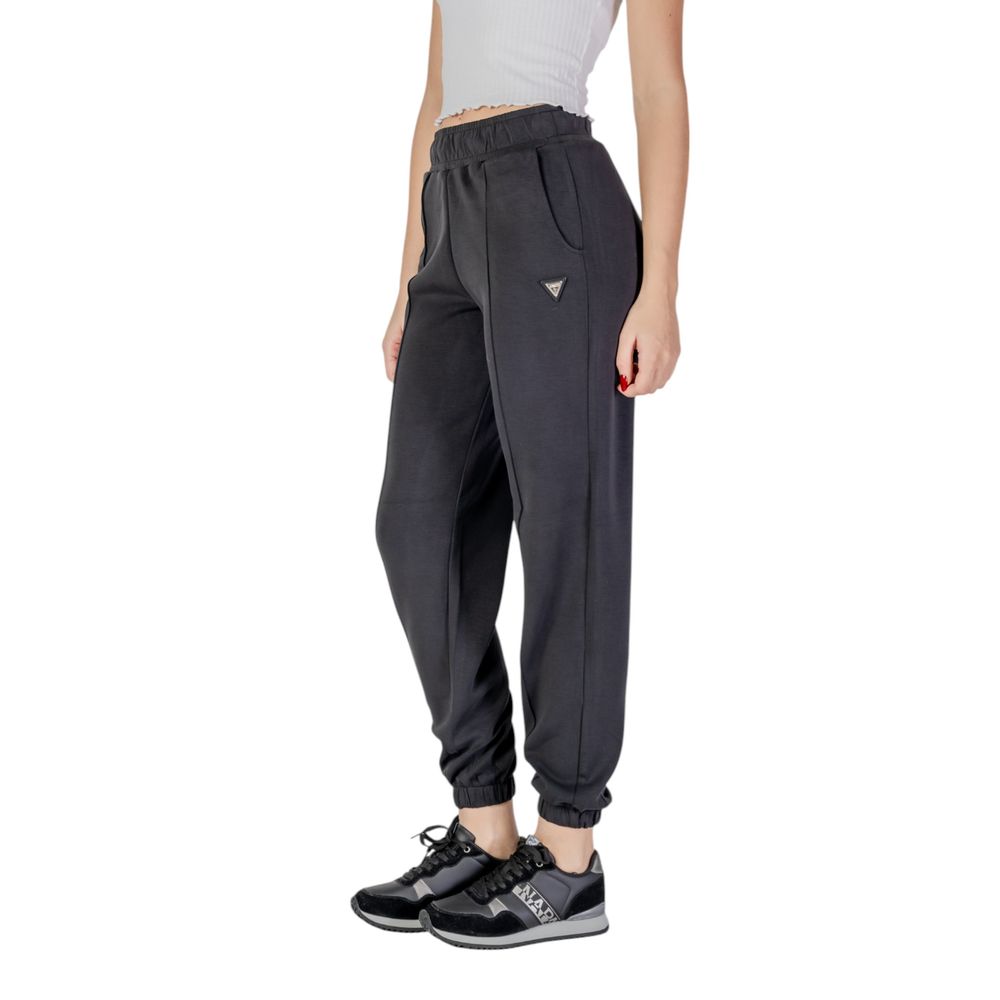 Pantalons de jogging Guess Active en polyester noir, style décontracté pour le sport ou la détente, visibles sur l'image.