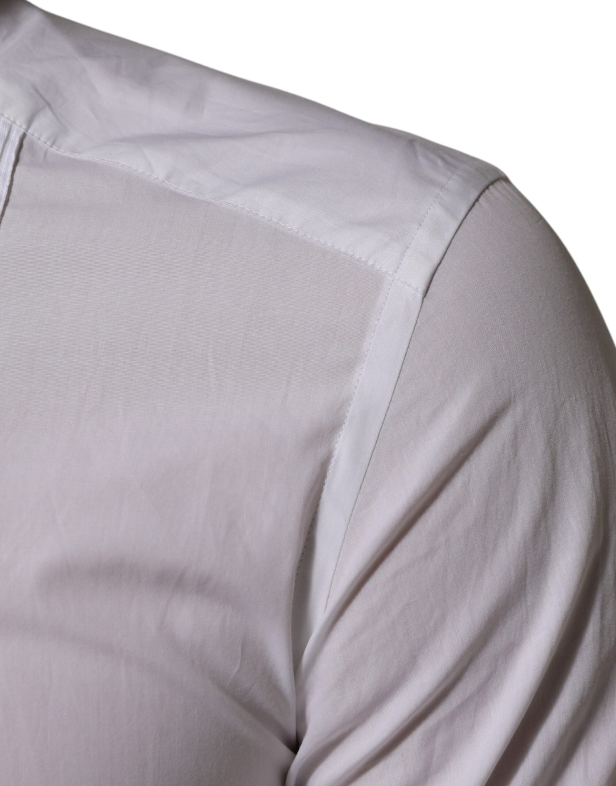 Chemise blanche à col en coton Dolce & Gabbana, manches longues avec détails dorés, élégante et sophistiquée.