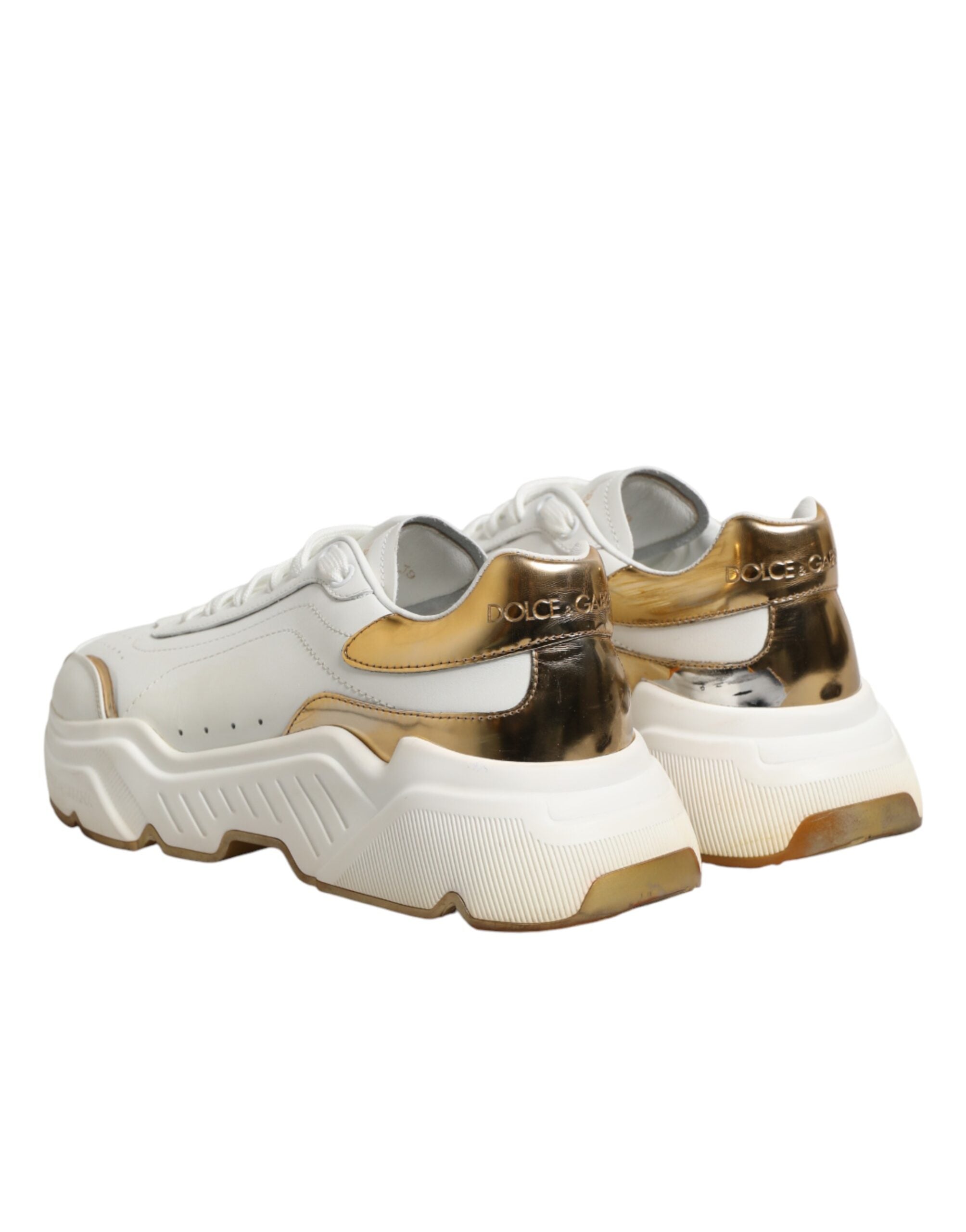 Chaussures Dolce & Gabbana Daymaster blanches en or à basse tige, sneakers élégants en cuir avec détails dorés.