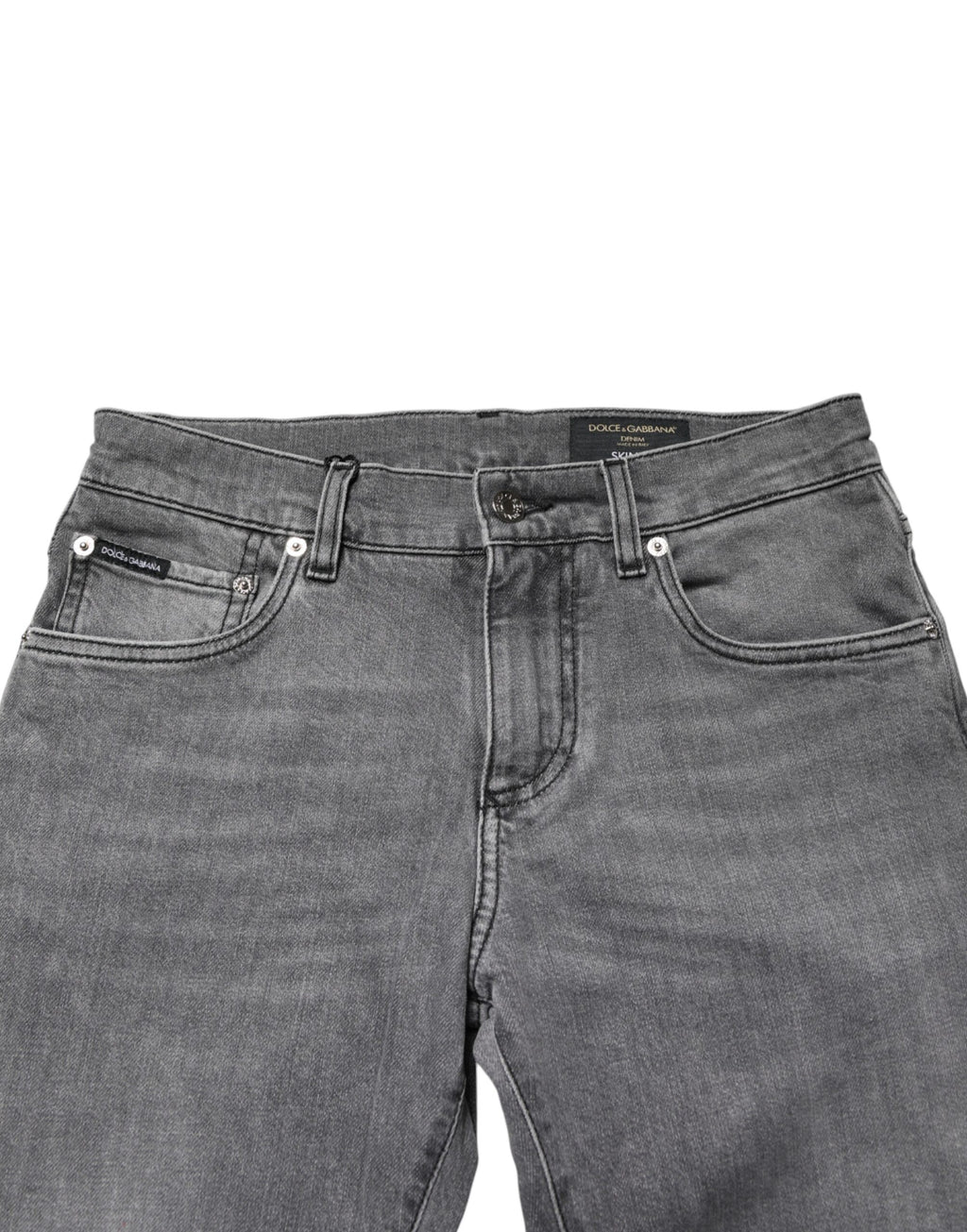 Jeans slim en coton gris Dolce & Gabbana à taille moyenne, coupe skinny, visible en détail sur l'image.
