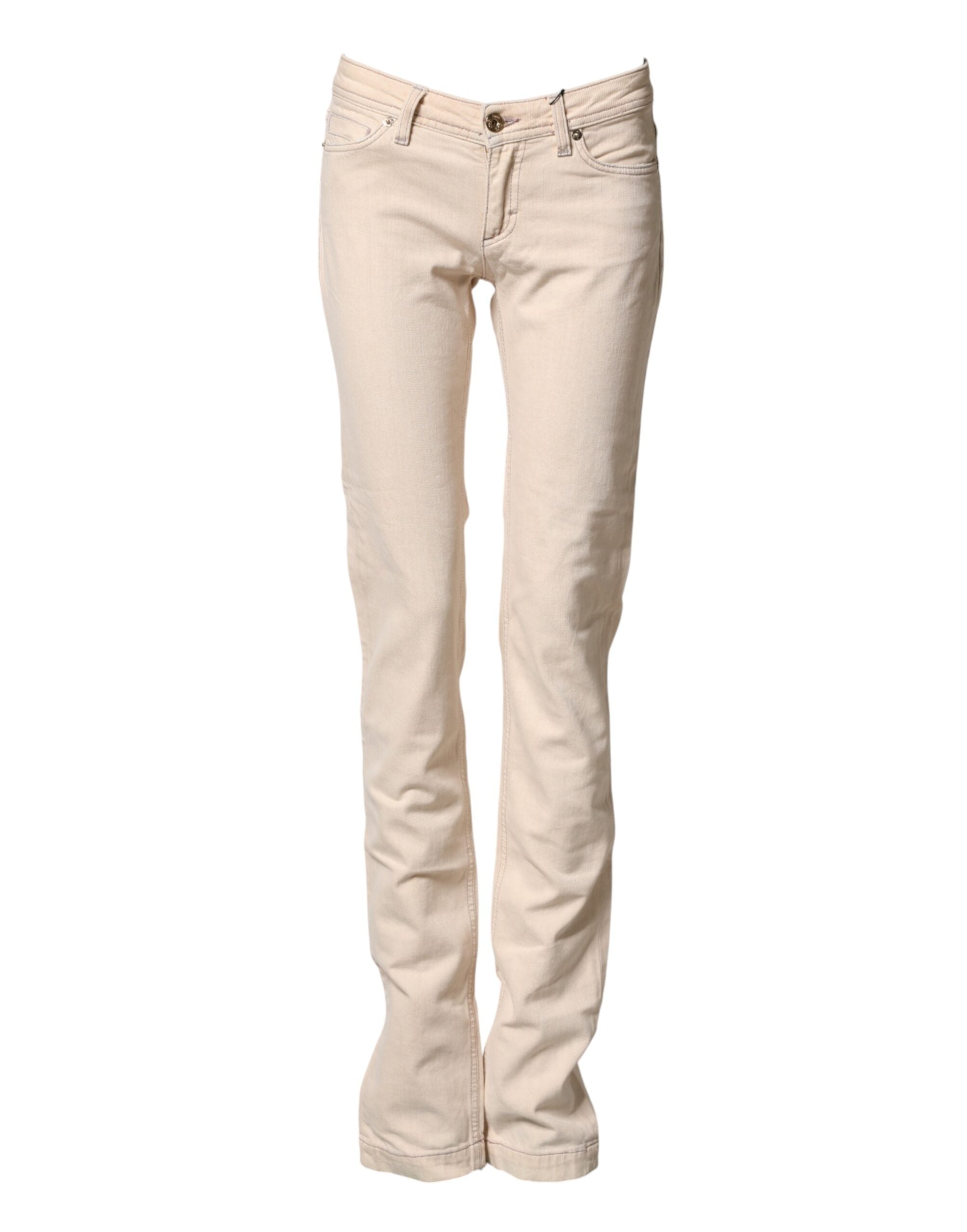 Pantalons en jean slim beige à taille basse en coton de Dolce & Gabbana, coupe ajustée et style décontracté.