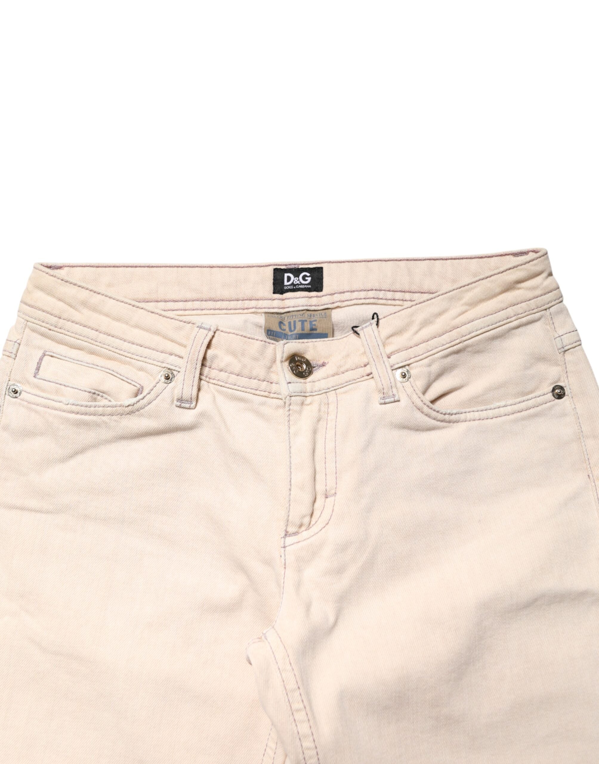 Jeans Dolce & Gabbana beige en coton, taille basse, coupe slim, pantalons en denim pour homme, visibles sur l'image.
