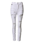 Jeans en denim blanc déchirés à taille haute de Dolce & Gabbana, style décontracté et tendance, avec détails usés visibles.