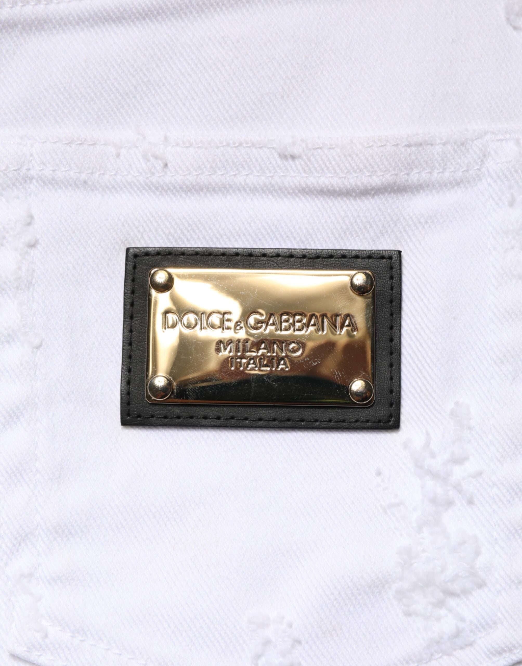 Jeans en denim blanc Dolce & Gabbana, taille haute, délavé avec un style déchiré, visible sur l'image.