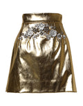 Jupe courte haute en acétate dorée avec cristaux Dolce & Gabbana, style élégant et brillant.