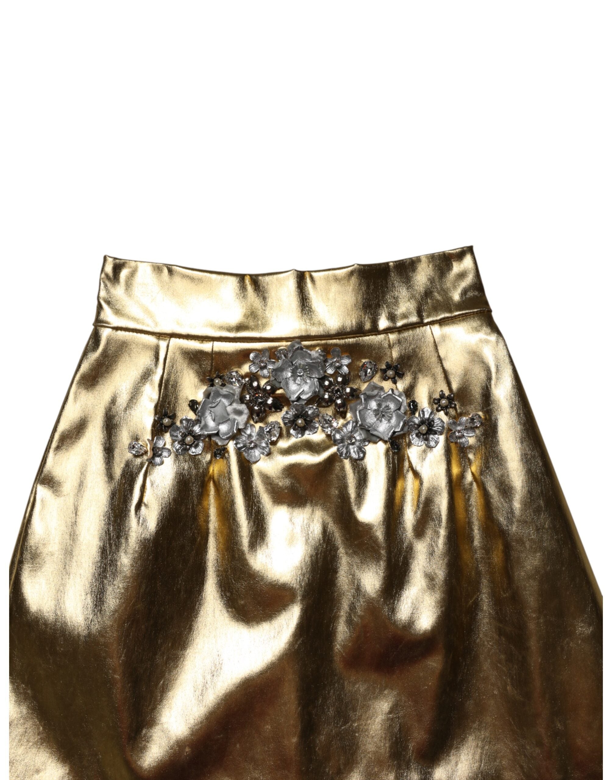 Mini jupe Dolce & Gabbana en acétate dorée avec cristaux, taille haute et style élégant, visible en image.