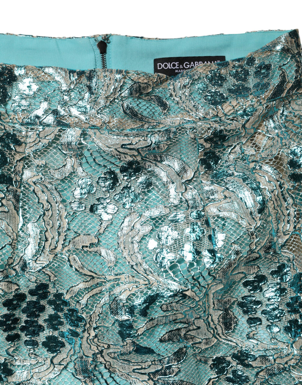 Mini jupe à taille haute Dolce & Gabbana en brocart floral bleu, élégante et sophistiquée, visible en détail.
