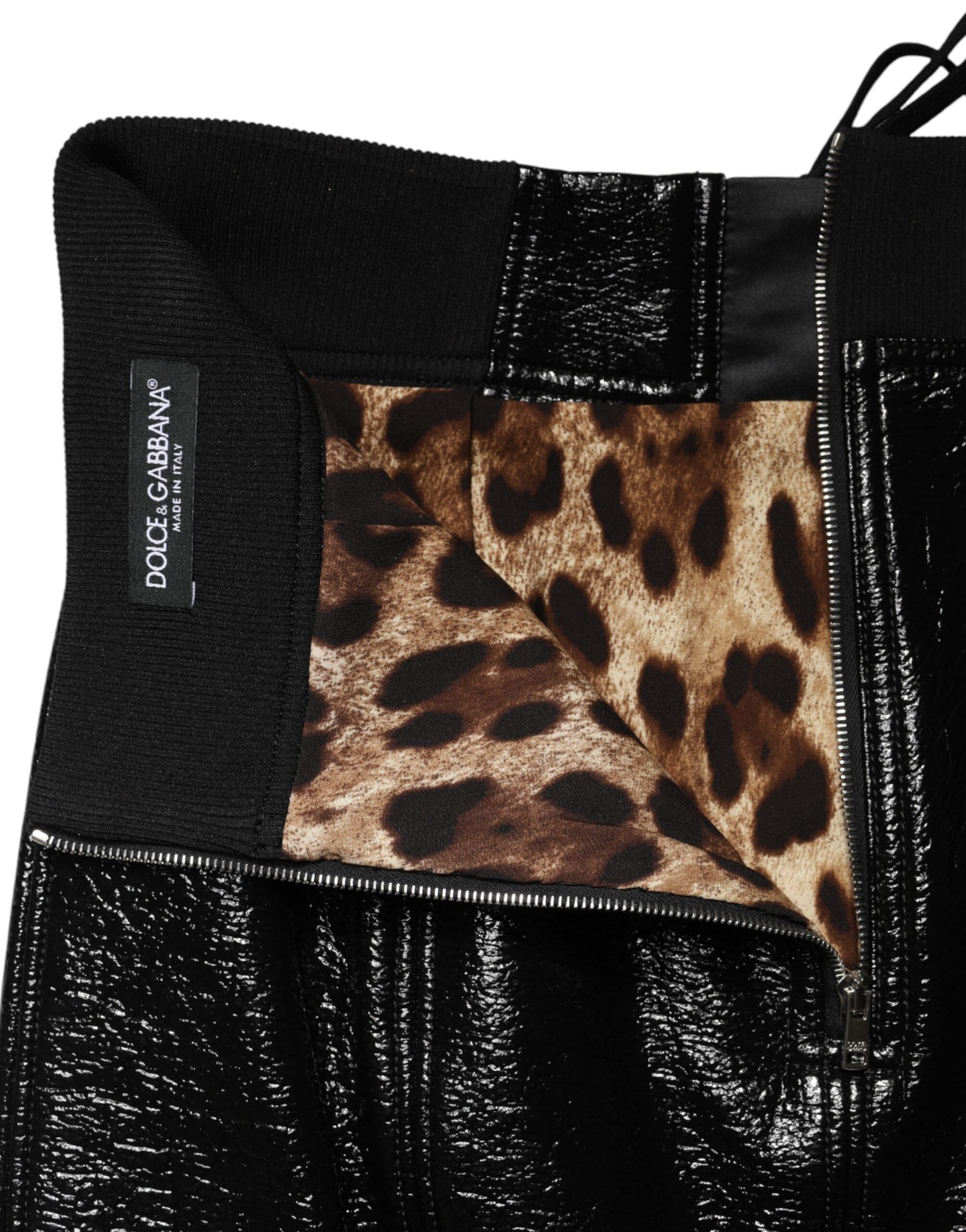 Mini jupe en nylon noir Dolce & Gabbana avec œillets et finition enduite, élégante et moderne.