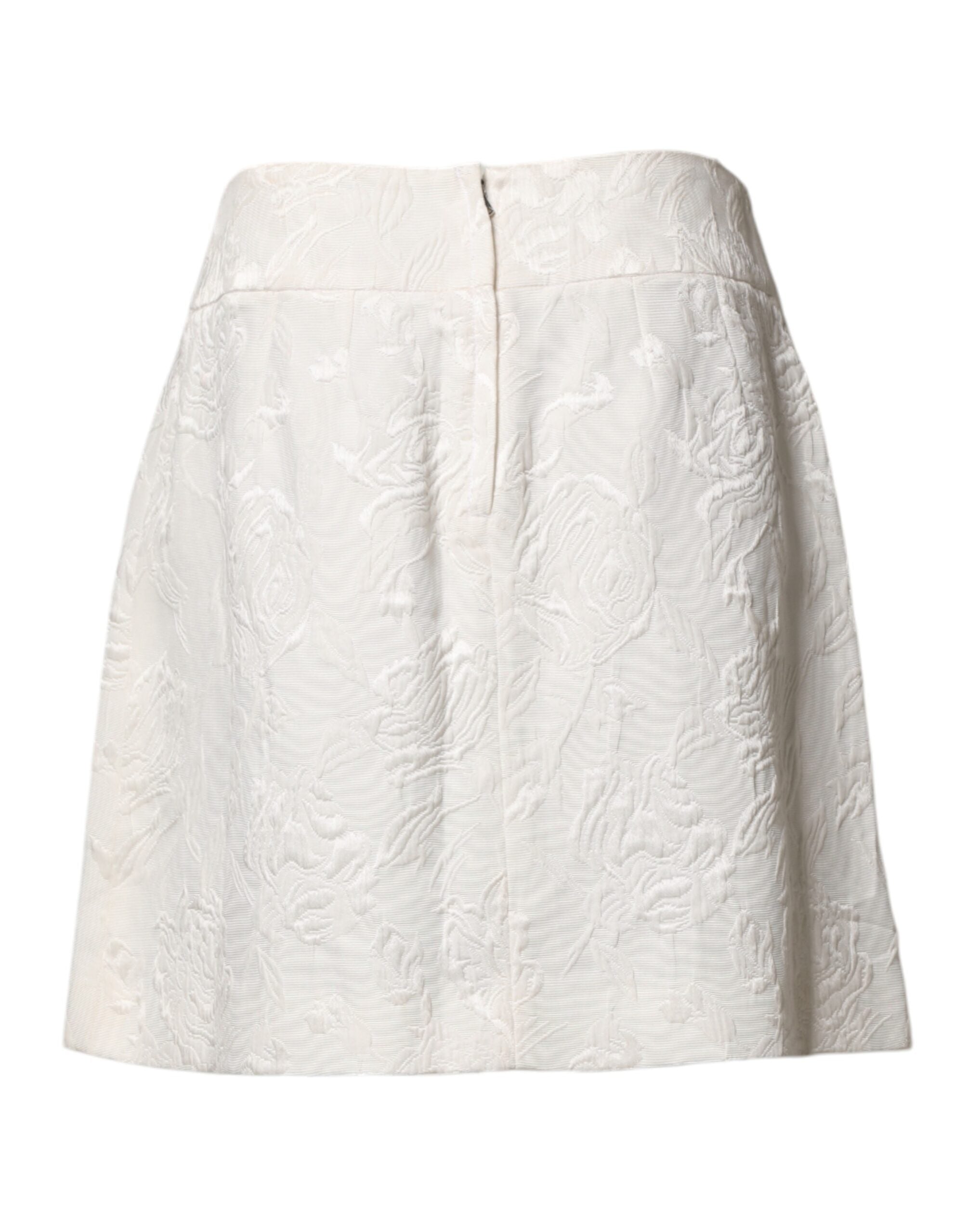 Jupe courte blanche en brocart floral Dolce & Gabbana à taille haute, visible avec détails de tissu et motif floral.