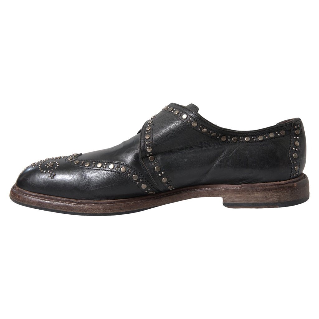 Chaussures habillées en cuir noir Dolce & Gabbana avec bride monk et clous, style élégant pour homme.