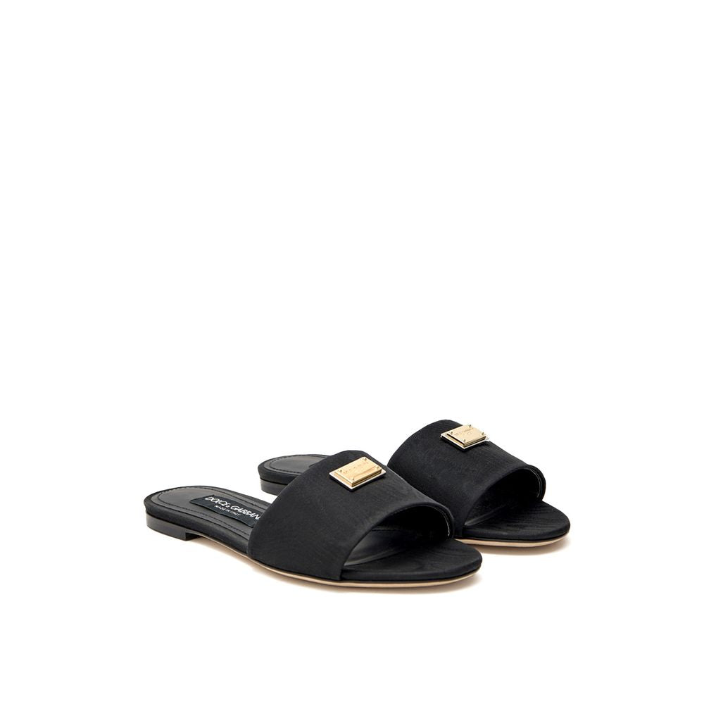 Chaussons en polyester noir de Dolce & Gabbana, élégants et confortables pour un style sophistiqué.