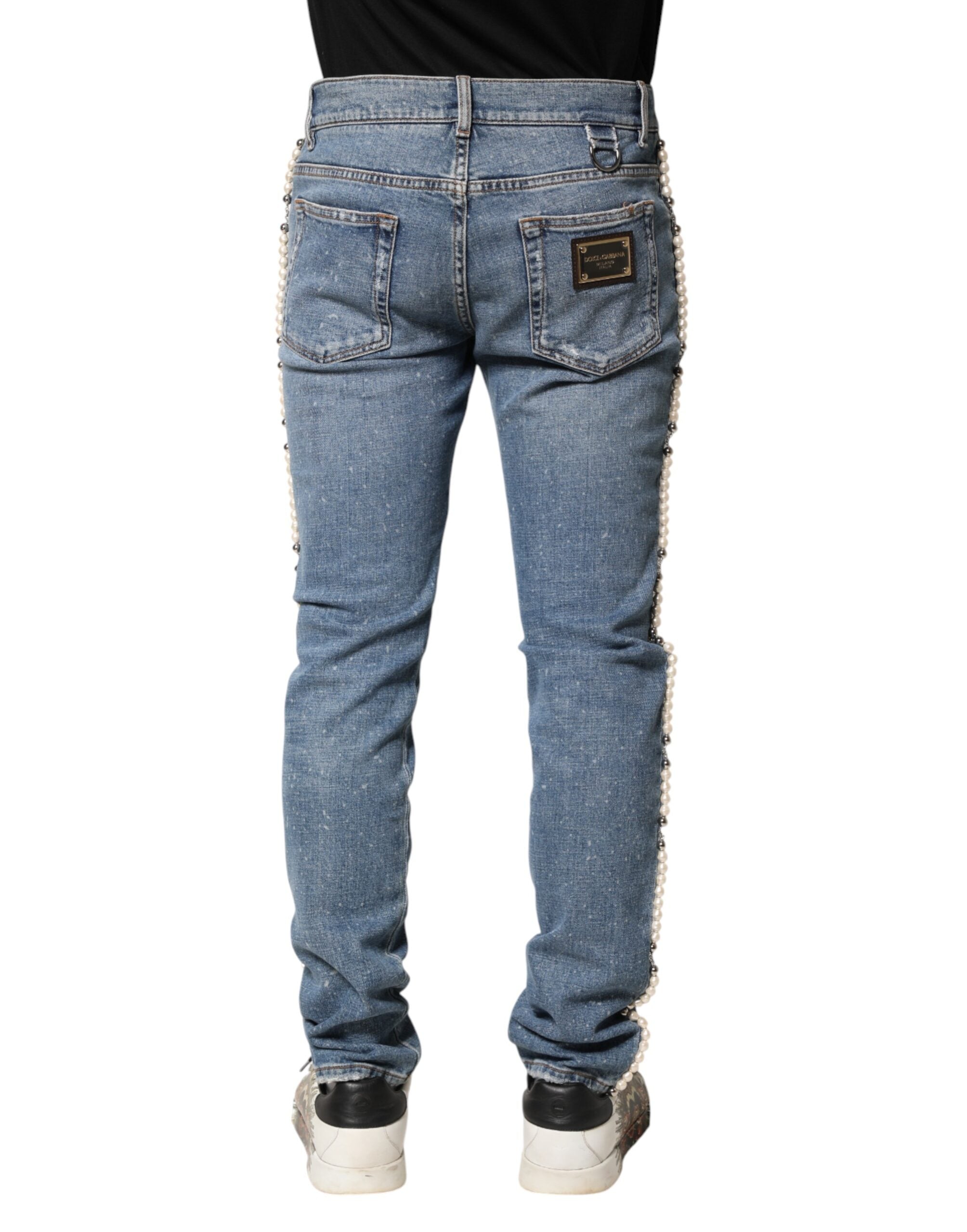 Jeans skinny en denim coton bleu Dolce & Gabbana avec embellissements visibles, mode élégante et sophistiquée.
