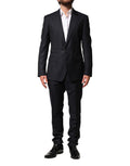 Costume homme noir Dolce & Gabbana en laine à deux pièces, veste croisée et pantalon, élégant et sophistiqué.