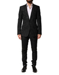 Costume homme Dolce & Gabbana en brocart noir, deux pièces, veste à double boutonnage et pantalon élégant.