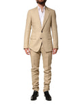 Costume 2 pièces en lin beige de Dolce & Gabbana, veste à boutonnière simple et pantalon assorti.