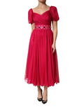 Robe midi en soie rose Dolce & Gabbana avec embellissements, coupe évasée et détail élégant visible sur l'image.