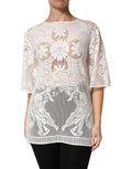 Blouse blanche en coton avec broderie en dentelle de Dolce & Gabbana, élégante et raffinée, portée sur un mannequin.