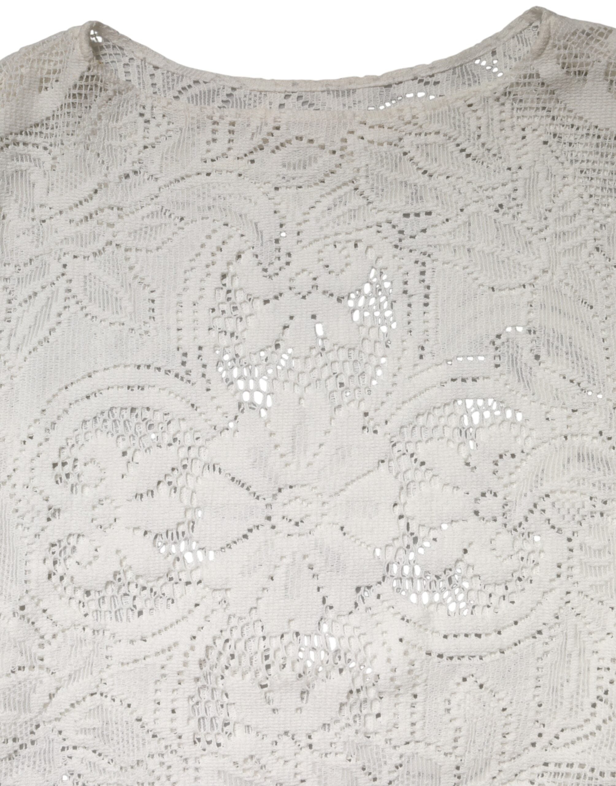 Chemisier blanc en coton avec broderies en dentelle Dolce & Gabbana, style élégant et féminin visible sur l'image.