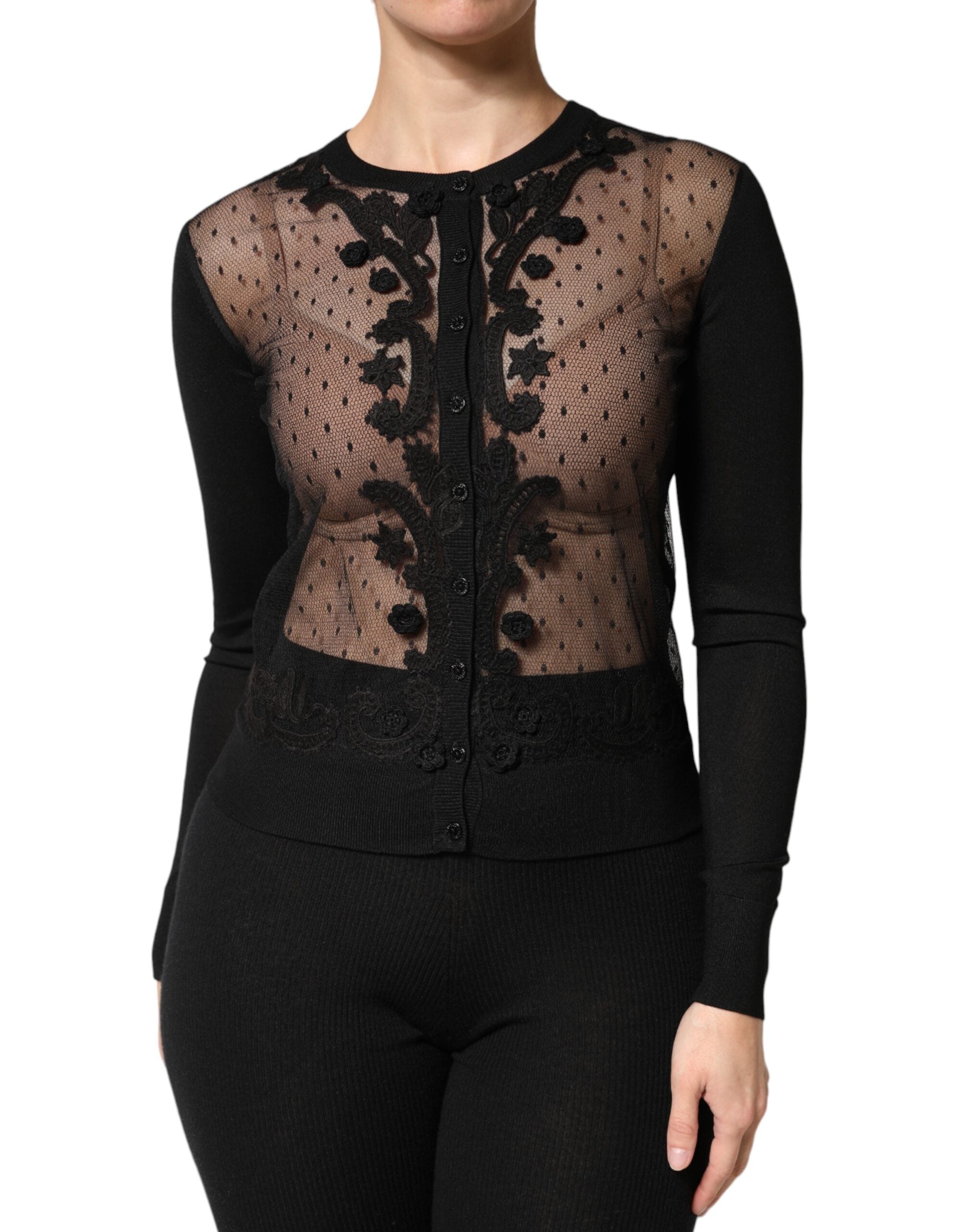 Cardigan noir en maille transparente Dolce & Gabbana à boutons, porté ouvert avec col en V et manches longues.