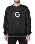 Sweat-shirt noir Dolce & Gabbana avec logo DG sur le col rond, en coton, porté sur un mannequin, vue de face.