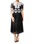 Robe midi en soie noire et blanche avec dentelle en macramé de Dolce & Gabbana, élégante et sophistiquée.