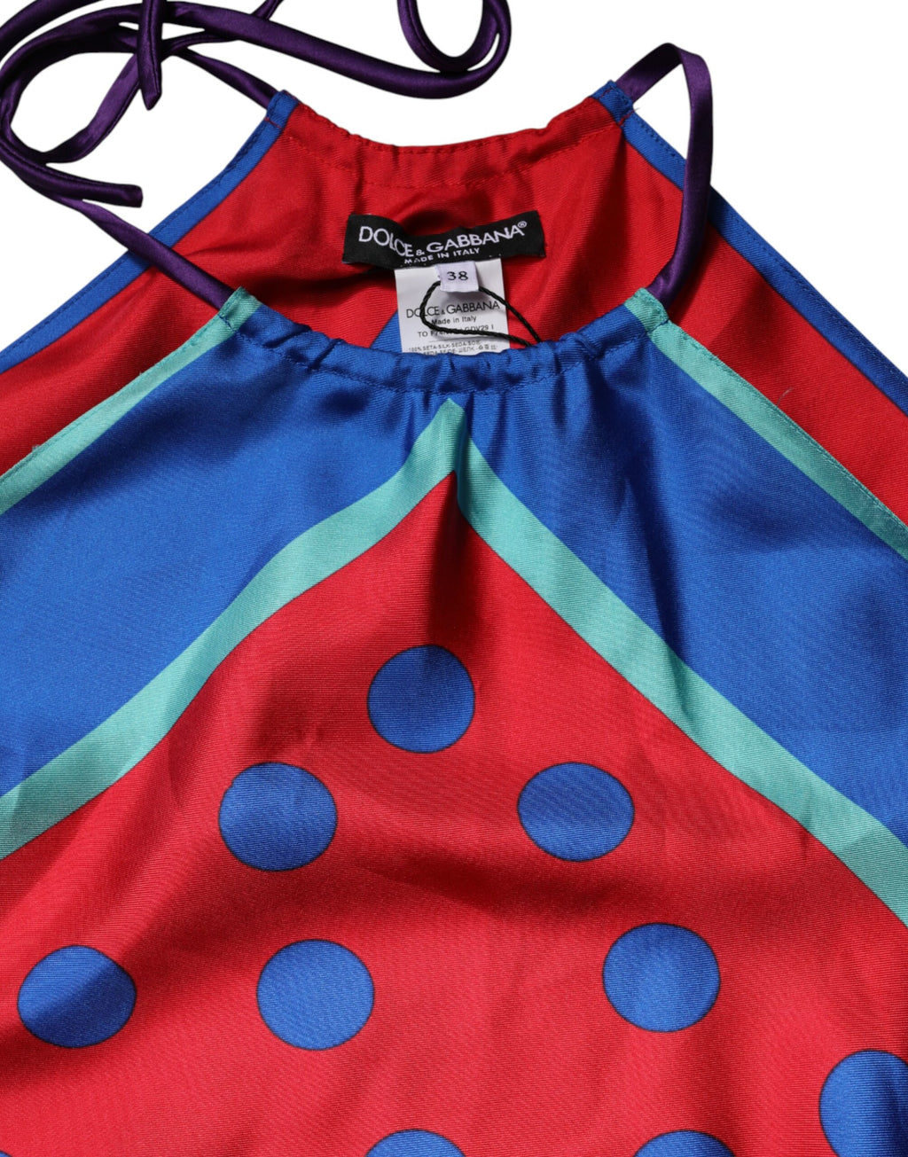Haut Dolce & Gabbana à pois multicolores avec col halter, en tissu léger, porté sur mannequin blanc.