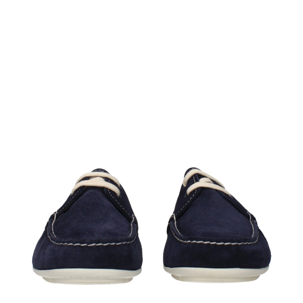 Chaussures bateau en cuir bleu de Prada, mocassins slip-on élégants pour homme, finition raffinée et style moderne.