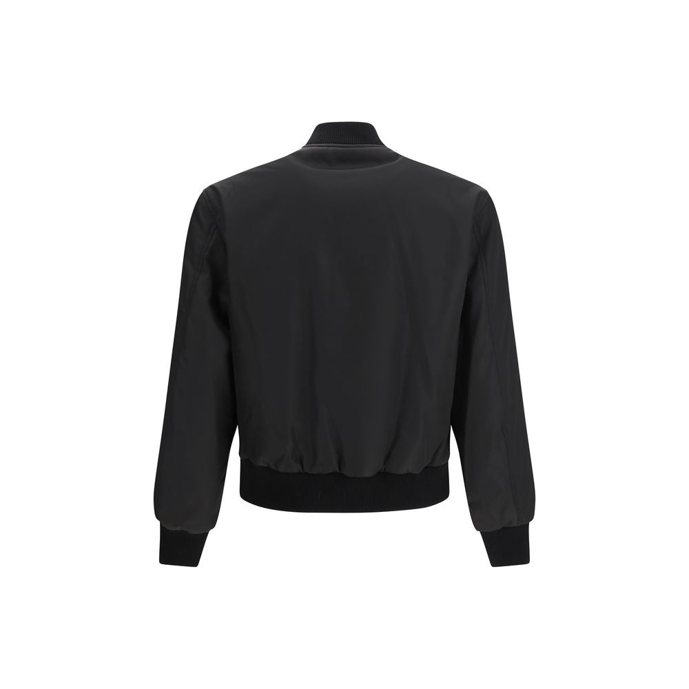 Veste noire en polyamide de la marque Versace, style élégant avec détails sophistiqués, vue de face sur un fond neutre.