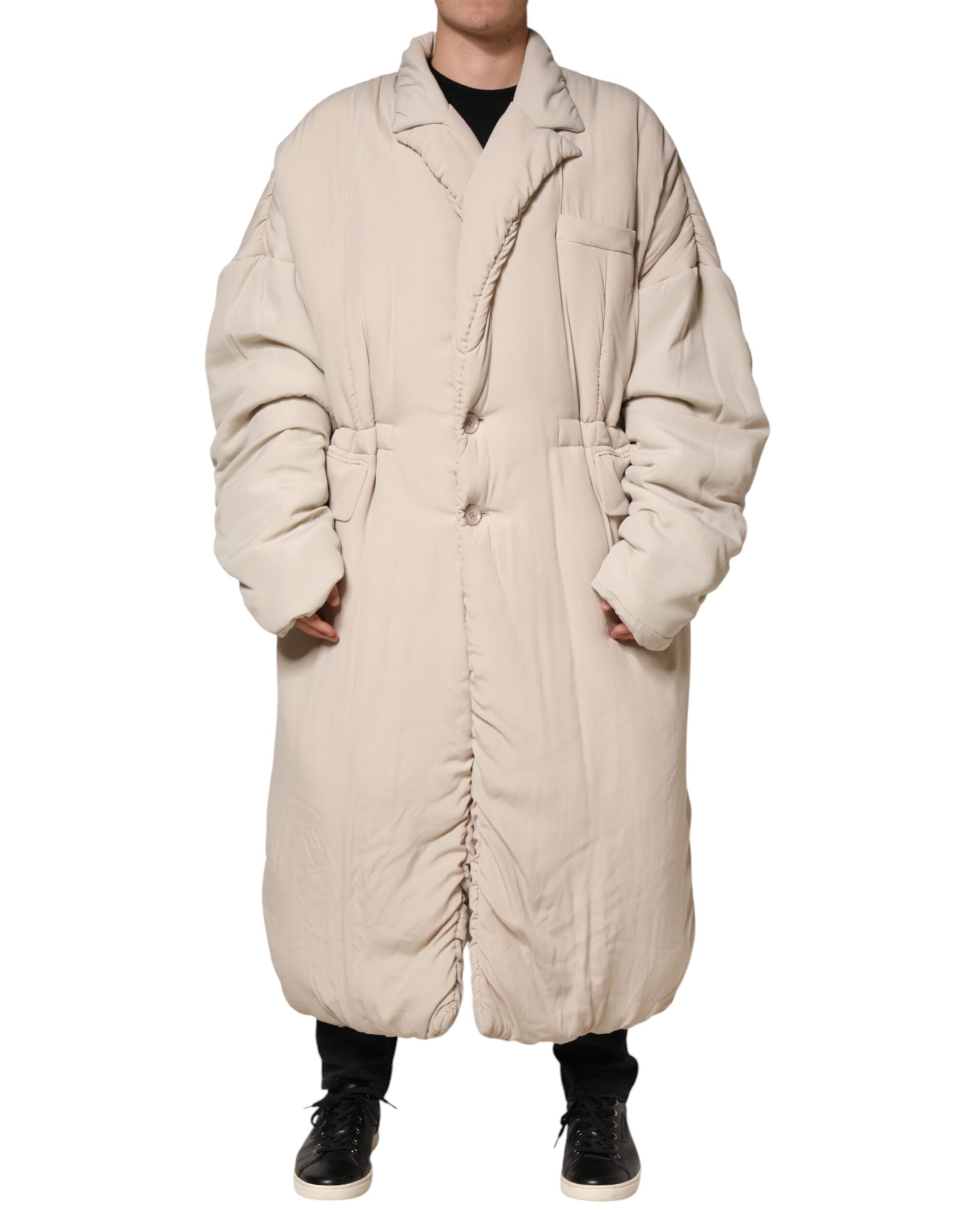 Manteau long beige Dolce & Gabbana avec col rembourré, veste trench élégante, coupe moderne et détails sophistiqués.