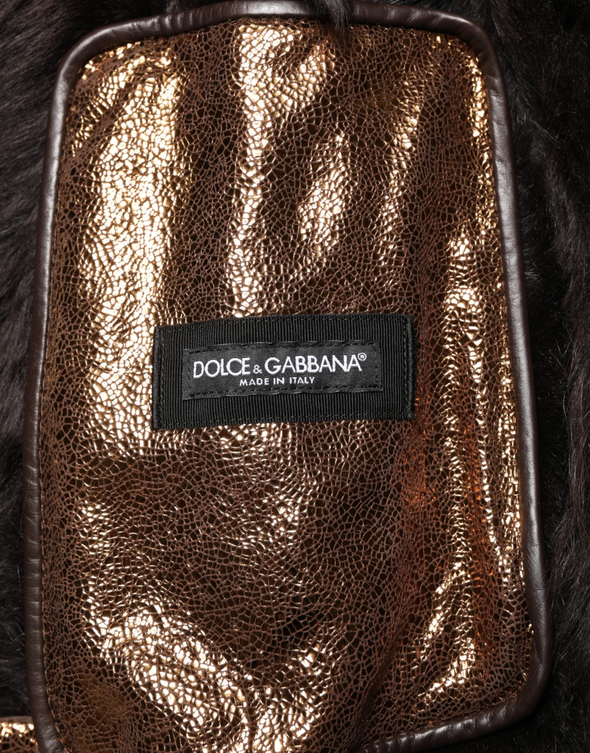 Veste biker en cuir bronze avec fourrure complète de Dolce & Gabbana pour homme, fermée par zip, style élégant et audacieux.