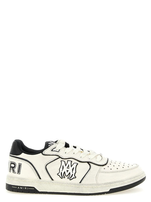 Baskets basses amiri bicolor en cuir bovin blanc avec accents noirs et logo stylisé sur la côte perforée