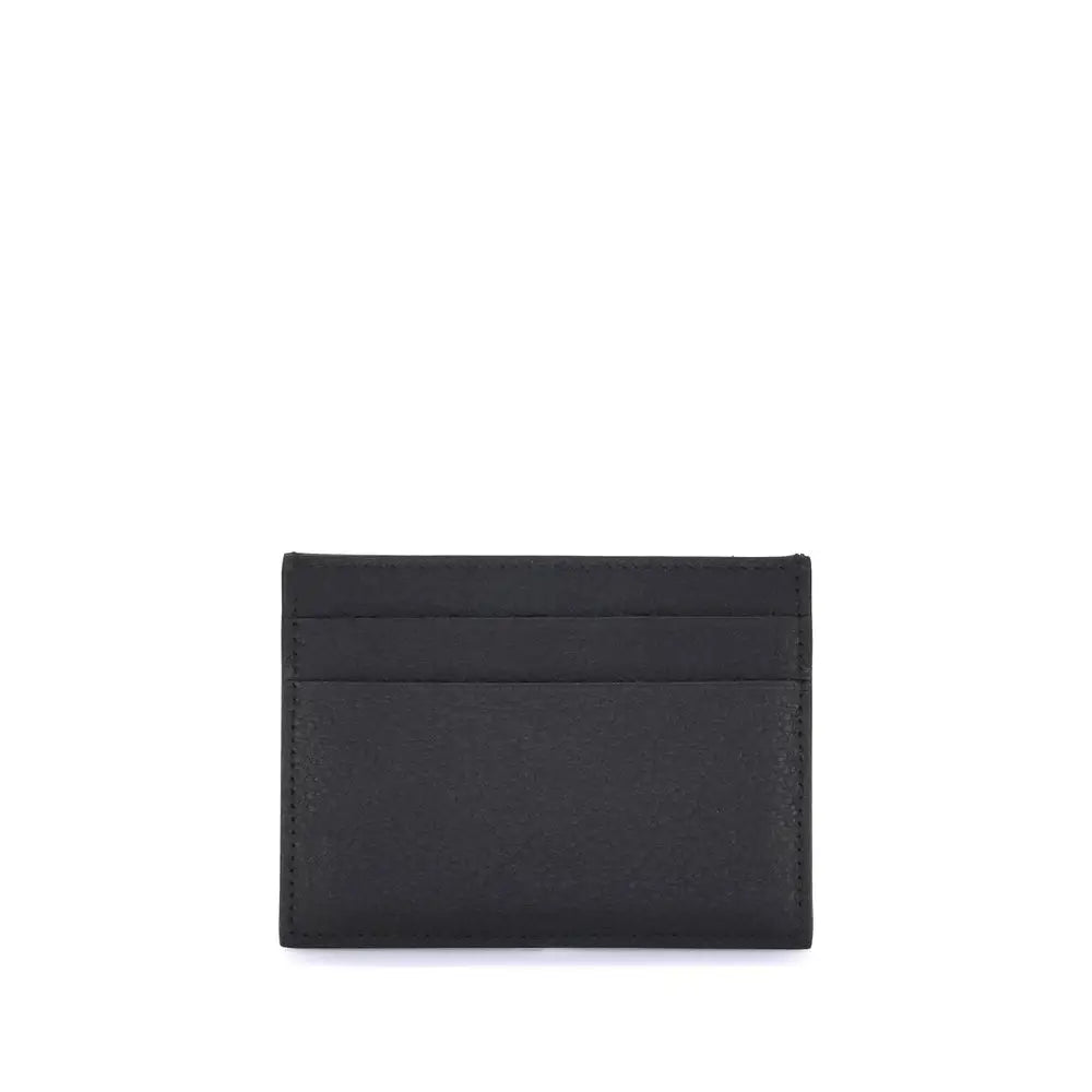 Porte-cartes balenciaga en cuir dagneau noir avec trois fentes horizontales et couture visible sur les bords