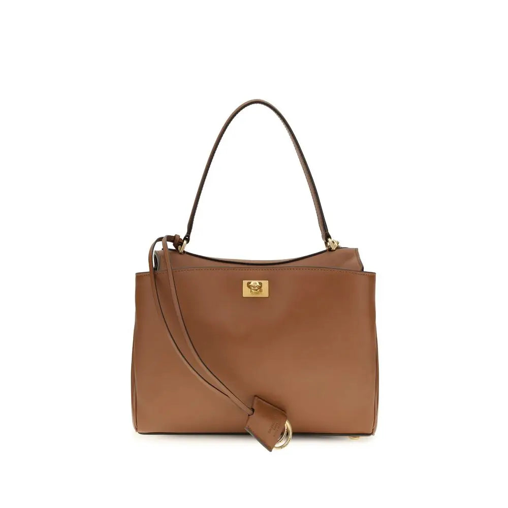 Un sac tote en cuir de veau marron balenciaga avec une fermeture dorée et une bandoulière assortie