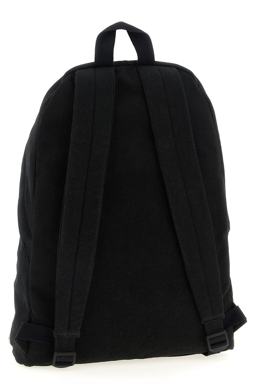 Sac à dos en coton noir Balenciaga, avec logo discret, porté sur une personne, style moderne et élégant.
