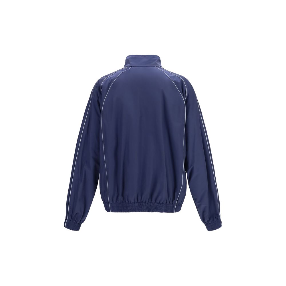 Veste en coton bleu Balenciaga, coupe shell, avec fermeture éclair et col montant, vue de face sur fond blanc.
