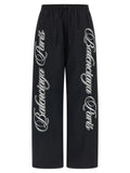 Pantalon larges balenciaga paris noir en polyamide avec logo blanc cursif sur chaque jambe pour usage sportif multicolore