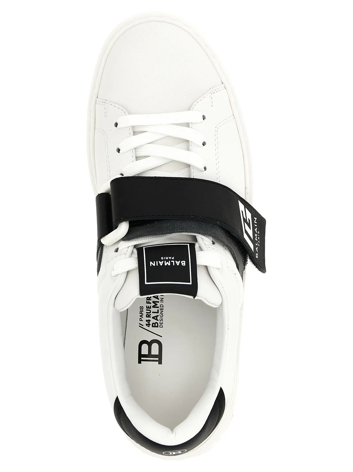 Baskets basses balmain bicolor en cuir de veau blanc avec bride velcro noire et accents noirs au talon et languette